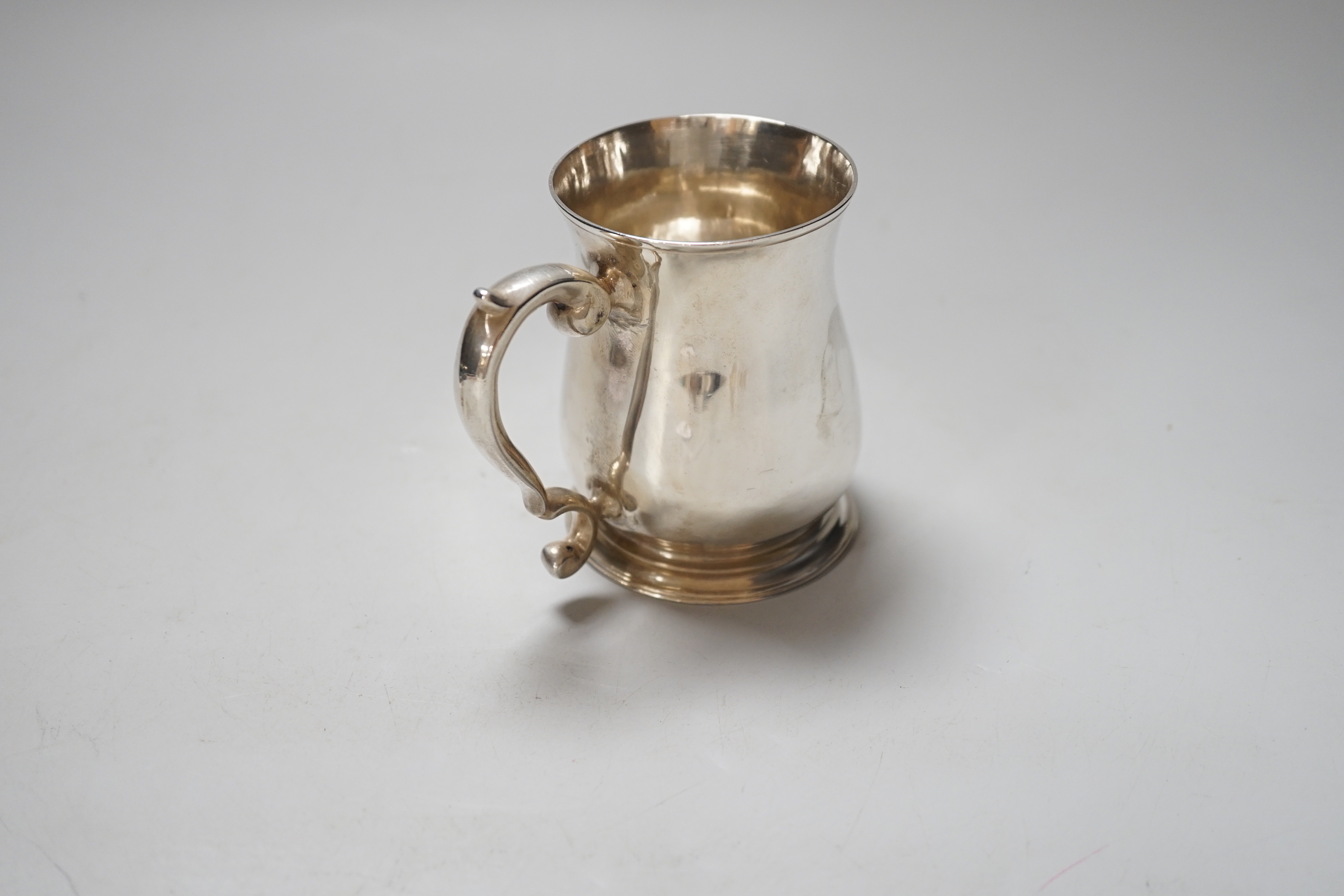 A George II silver baluster mug with scroll handle, makers mark rubbed, London 1752, 9cm, 160 grams